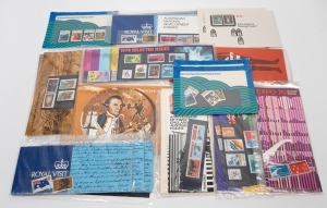 Accumulation of 1969-73 post office packs in shoe box, mostly sealed in plastic types. (36 items)