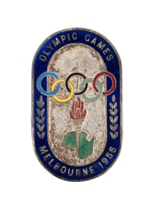 Ballarat Olympic Village commandant F.H. Christison's personal Melbourne 1956 Olympic Official pin badge, in oxidised silver with blue enamelled border and enamelled Olympic rings, torch, and map of Australia; stamped "3835" on reverse, manufactured by K.C. Luke (Melbourne), dimensions 51 x 30 mm, weight 20 grams.