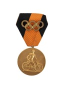 1936 BERLIN: First Place Winner&rsquo;s Medal in Pre-Olympic Cycling competition, April 10th 1936, 33mm, gilt, depicting a cyclist on on the front and with the date engraved on reverse, incl. black and orange ribbon with affixed gilt Olympic rings.