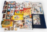 An accumulation mostly consisting of stamp and coin items, including an 1881 United States Morgan Silver Dollar, a 1937 Australian silver Crown, several Australia Post stamp packs, first day covers, an eclectic mix of trading cards, and much else besides.