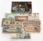 An old metal cash tin containing an accumulation of World coins and a few banknotes.