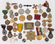 An accumulation of Australian and foreign medals, medalets, fobs, buttons and badges, all contained in an old cigar box. (40+ items). Happy hunting!
