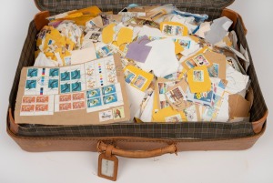 An old time leather calfskin suitcase, containing an enormous accumulation of world stamps, mostly still on piece. Inspection recommended.
