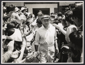 92 · DON BRADMAN - DECEMBER 1948 MCG TESTIMONIAL MATCH: Original press photograph showing Bradman leading his team onto the Melbourne Cricket Ground through a throng of supporters; 15 x 20cm.