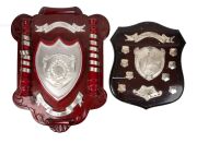 Two original wooden shield plaques recovered from the Swans clubhouse in the wake of the 1977 fire, comprising one inscribed "Leigh McCarthy Memorial Trophy - South Melbourne Under 19s 1976" (height 80.5cm), and the other inscribed "Shell South Melbourne 