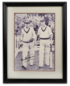 DON BRADMAN: Original signature on reproduction photograph of Bradman walking out to bat with Bill Brown; framed and glazed, 39 x 31.5cm overall.