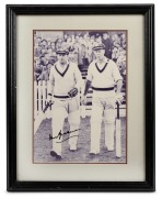 DON BRADMAN: Original signature on reproduction photograph of Bradman walking out to bat with Bill Brown; framed and glazed, 39 x 31.5cm overall.