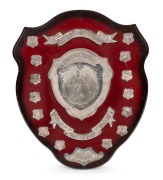 SWANS BEST & FAIREST AWARD: Original ornate wooden shield with metal plaque and annual additions, inscribed "South Melbourne Football Club - Perpetual Trophy - Best And Fairest Award - Donated By Yellow Cabs Of Australia", engraved Russell Cook 1972, Pete