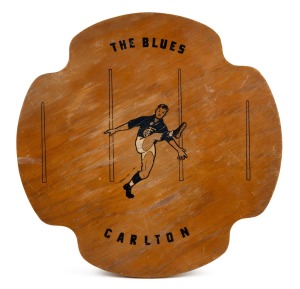 CARLTON: Circa 1930s 41.5 x 41.5cm wooden platter featuring text "The Blues - Carlton" and an illustration of a Carlton player in action in front of a set of goal posts.