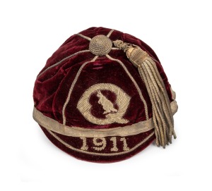A QUEENSLAND 1911 HONOUR CAP, awarded to a member of the State team which played against New South Wales on June 7, 1911; maroon velvet with wire embroidered "Q" around a kangaroo over the date "1911" and full tassle; black internal lining. In exceptionally fine condition. Accompanied by an original Talma RP postcard of the team. Provenance: the Estate of Jack "Darb" Hickey (1887 - 1950), who was a member of the opposing New South Wales team and who evidently exchanged his cap for this one.
