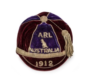 AN AUSTRALIAN KANGAROO TOUR TEAM 1912 HONOUR CAP, awarded to a member of the team which toured Great Britain, where they became the first-ever touring side to win The Ashes; maroon and deep navy velvet, with wire embroidered "ARL (kangaroo) AUSTRALIAN" over the date "1912" and full tassle; black internal lining and the "Finney Isles & Co. Ltd. Queensland" maker's label. In exceptionally fine condition. Provenance: the Estate of Jack "Darb" Hickey (1887 - 1950) who appears to have been included.