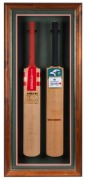 Attractively framed and glazed pair of full-size cricket bats: a Gray Nicolls "Ashes '89" bat signed by the Australian team (including Allan Border, Dean Jones, David Boon, Ian Healy, Greg Chappell, and Bob Simpson), together with a 1996-97 Test Series so