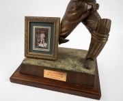 DONALD BRADMAN: Bronze statuette on jarrah plinth with plaque "The Cricketer Of The Century", limited edition 166/200, approx. 53 x 36 x 25cm; framed trading card (17 x 14.5cm overall) with original Bradman signature has been attached to the base (later a - 2