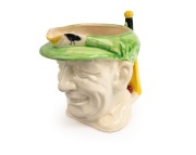1936 Don Bradman toby jug manufactured by Marutomo Ware, with cap in green, height 15cm.