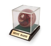 SHANE WARNE: Signed A.G. Thompson Kookaburra Turf cricket ball in perspex case with CoA, c. 2000s.