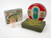 Melbourne Olympics "Souvenir Cushion", two colour lithograph biscuit tins, a glass beaker, plus a Tokyo 1964 Olympics glass beaker, (5 items). the cushion 22cm wide.
