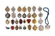 Diverse group of sixteen football pins and fobs, including noted VFA (1954, 1955 x 2, and 1968), TANFL Representative Team, and 1982 S.A. Football Trainers Association, plus fifteen blank K.G. Luke or Stokes medals. (31 items)
