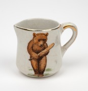 1920s porcelain milk jug bearing transfer of bear playing cricket, height 4.5cm.