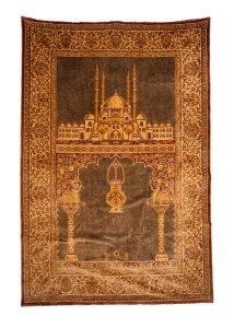 A hand-knotted black and red tribal prayer rug; together with a machine made wall hanging depicting the mosque of Sultan Salim in Adrianople, (2 items), the wall hanging 190 x 126cm.