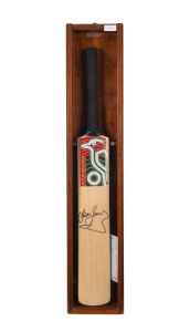 DEAN JONES: Kookaburra cricket bat signed to the face in black marker, housed in custom-built glazed wooden display box with CoA; height 94cm.