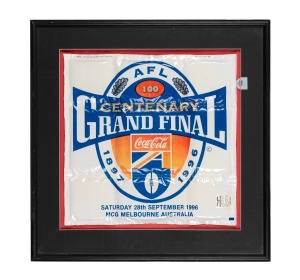 AFL CENTENARY: Original ink illustration commissioned for television advertisement during the AFL Centenary year, with the artist's four window-mounted reference photographs arrayed at bottom, framed and glazed, 66.5 x 61.5cm overall, together with framed and glazed inflatable novelty 'Airbox', prominently featuring Centenary logo and date of the match, 62 x 62.5cm overall. (2 items)