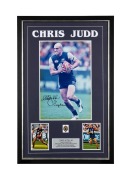 CHRIS JUDD: Framed display featuring a signed action photograph, a replica Brownlow medal, and details of his career highlights, with CoA verso; 85 x 55.5cm overall.