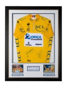 2013 TOUR DE FRANCE: Yellow jersey signed by Simon Gerrans and Daryl Impey, the two Orica GreenEDGE riders to have worn the jersey in that years events; attractively framed and glazed, 101 x 76.6cm overall.