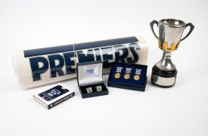 GEELONG: Royal Selangor pewter miniature Premiership cup, height 21cm, engraved "Australian Football League 2009 Premiership Cup - Won By Geelong", with plaque on base showing players in their positions, together with two sets of cufflinks, 2011 Premiers deck of playing cards, and four laminated Premiership posters. (8 items)