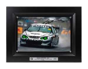 CRAIG LOWNDES - 2001: Ten identical framed and glazed signed photographs of Lowndes in his Gibson Motorsport AU XR8 Falcon, limited edition 81-90/100, each 33 x 43cm overall. (10 items)