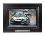 CRAIG LOWNDES - 2001: Ten identical framed and glazed signed photographs of Lowndes in his Gibson Motorsport AU XR8 Falcon, limited edition 61-70/100, each 33 x 43cm overall. (10 items)