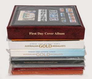 An accumulation of Australian decimal stamps, including five Australia Post Stamp Yearbooks spanning the years 1999 to 2003, the 2000 and 2004 "Australian Gold Medallists" stamp albums, an album of first-day covers, and others; FV $460+.