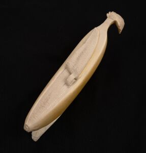 A Japanese carved whalebone banana ornament, early to mid 20th century, 13cm long.