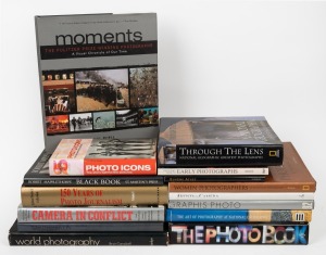 PHOTOGRAPHY: A shelf of books including "Graphis Photo 92," "Moments" by Buell, "Women Photographers" by Newman, "Robert Mappelthorpe" by Shange, "Artists in Camera" by Owen, "150 Years of Photo Journalism" by Yap, "Site Unseen 05," "Camera in Conflict" b