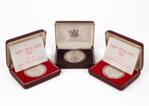 NEW ZEALAND: 1981 $1 Royal Visit silver Proof; 1983 $1 Royal Visit silver Proofs (2); all in original boxes of issue. (Total: 3).
