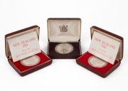 NEW ZEALAND: 1981 $1 Royal Visit silver Proof; 1983 $1 Royal Visit silver Proofs (2); all in original boxes of issue. (Total: 3).