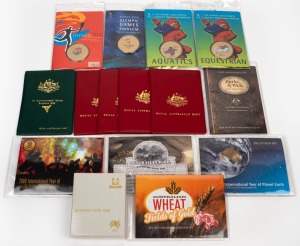 ROYAL AUSTRALIAN MINT: Group comprising 1979-1983 six-coin uncirculated sets (red or green wallets), 1988 $5 proof, 2008-2012 two-coin uncirculated sets, plus four Sydney 2000 Olympics medallion booklets. (