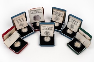 GREAT BRITAIN: SILVER PROOFS - ONE POUND: Group comprising years 1983 (2), 1983 (piedfort). 1984, 1985, 1986, and 1987; all in presentation cases with CoA. (7 items)