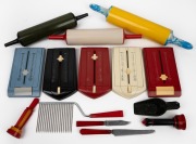 Bakelite rolling pins, Teledex, perfume bottles, sugar scoop, and three red handled implements, early to mid 20th century, (14 items), ​​​​​​​the largest 42cm long.