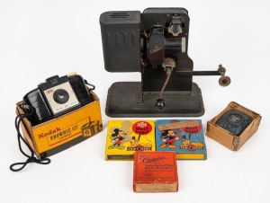 A vintage hand-crank projector; together with two Walt Disney films with original Mickey Mouse packaging, Kodak Brownie 127 in original box, German film in original box and a vintage German light meter in original box, (6 items), the projector 23cm high.