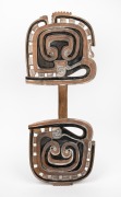 A tribal shield, carved wood with remains of piped clay and ochre finish, Sepik River, Papua New Guinea origin, 20th century, ​​​​​​​74cm high.
