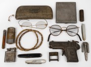 Three antique penknives including silver and mother of pearl, two pairs of antique spectacles (damaged), Railway gate key, vintage toy gun, gold finished armbands, silver plated cigarette case, three lighters, combination lock (code: BLOOD), and a cricket