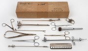 Group of twelve assorted steel medical instruments, predominantly long-handled forceps.