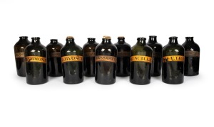 Eleven assorted antique glass apothecary jars, each individually labeled, some with original cork stoppers, late 18th century, the largest 35cm high.