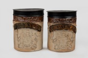A pair of antique English stoneware apothecary jars, decorated with English coat of arms and painted tin lids, 19th century, 19cm high, 13.5cm diameter.