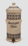 BERKEFELD antique German pottery water filter with coloured decoration, 19th century, 52cm high.