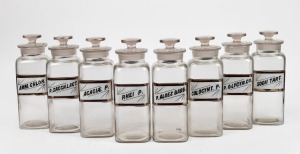 A set of eight assorted antique glass apothecary jars with original labels, 19th/20th century, 24cm high.