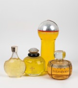 A group of four point of sale oversized perfume and cologne bottles, including YVES ST LAURENT and PIERRE CARDIN, 20th century, ​​​​​​​the largest 35cm high.