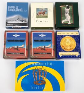 Group of RAM uncirculated $5 coins, all in presentation cases with box and CoA, comprising 1994 "Enfranchisement of Women", 1996 "Sir Donald Bradman", 1998 proof "Royal Flying Doctor Service" (2), 2000 proof "Phar Lap", and 2002 "Battle of Sunda Strait", together with 2002 "XVII Commonwealth Games Three Coin Set". (7 items)