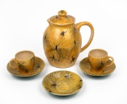 JOHN PERCEVAL & ARTHUR MERRIC BOYD lidded pottery jug on yellow ground, hand-painted with kangaroos and grass trees; together with two coffee cups and three saucers, (6 items), the cups incised "A.M.B. Perceval", the pot incised "Arthur Merric Boyd", the 