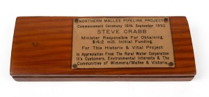 NORTHERN MALLEE PIPELINE PROJECT turpentine wood used in repair collar for timber water pipes, circa 1920, bearing presentation plaques, ​​​​​​​23cm wide.